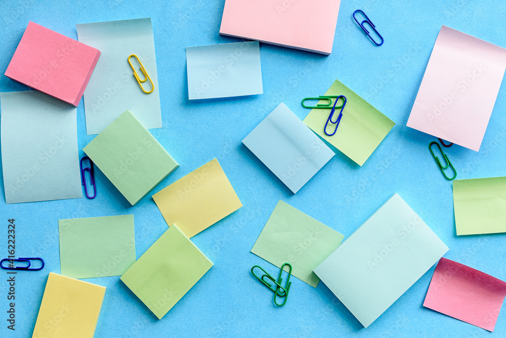 Top view of an office desk with stationery. Stickers on a blue background Top view of an office desk with stationery. Stickers on a blue background