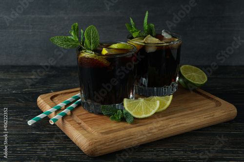 Board with glasses of Cuba Libre on wooden background