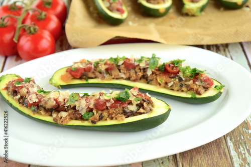 Zucchini boat filled with ground beef, mushroom, tomato sauce and parmesan cheese. Garnish with chopped parsley