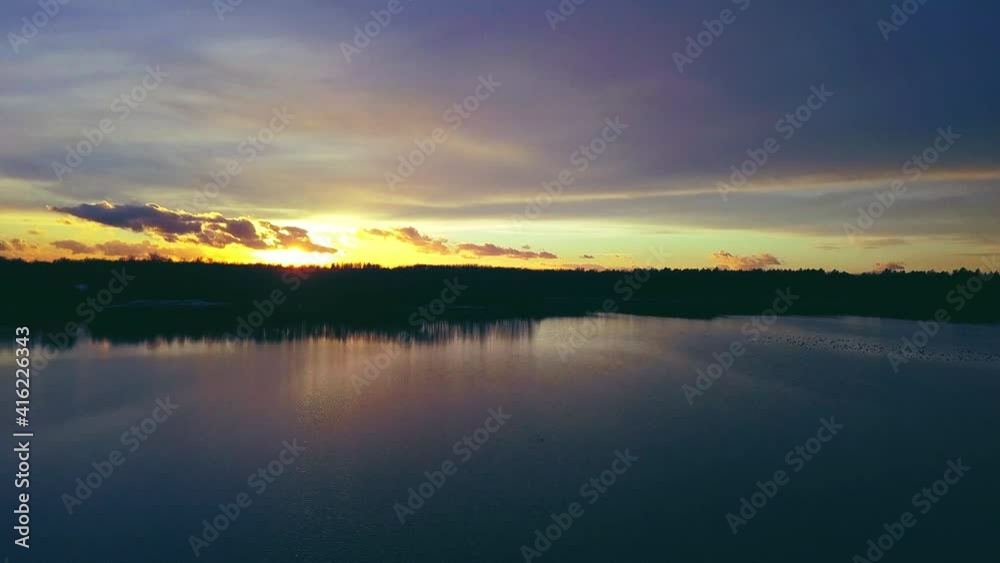 Hovering over a large and big lake at sunset. High quality 4k footage Hovering over a large and big lake at sunset. High quality 4k footage