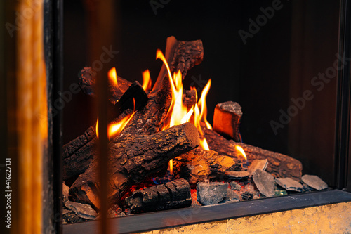 Wood logs burning in fireplace close up
