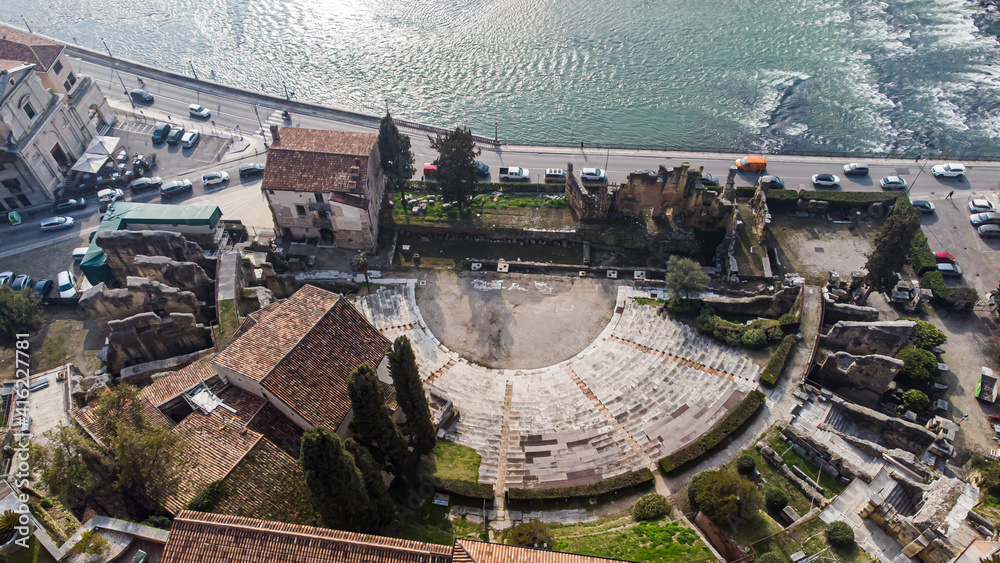 Aerial view of Verona crossed by the Adige river and shrouded in winter fog.