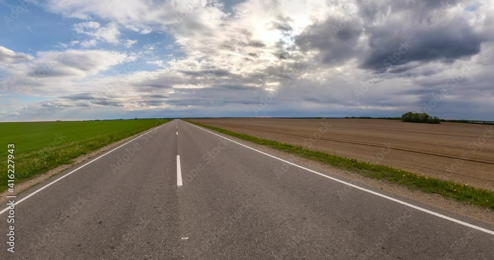 slowly rotating landscape with road and green field into a little planet. curvature of space. slowly rotating landscape with road and green field into a little planet. curvature of space.
