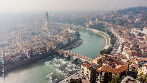 Obraz na płótnie Aerial view of Verona crossed by the Adige river and shrouded in winter fog. w salonie