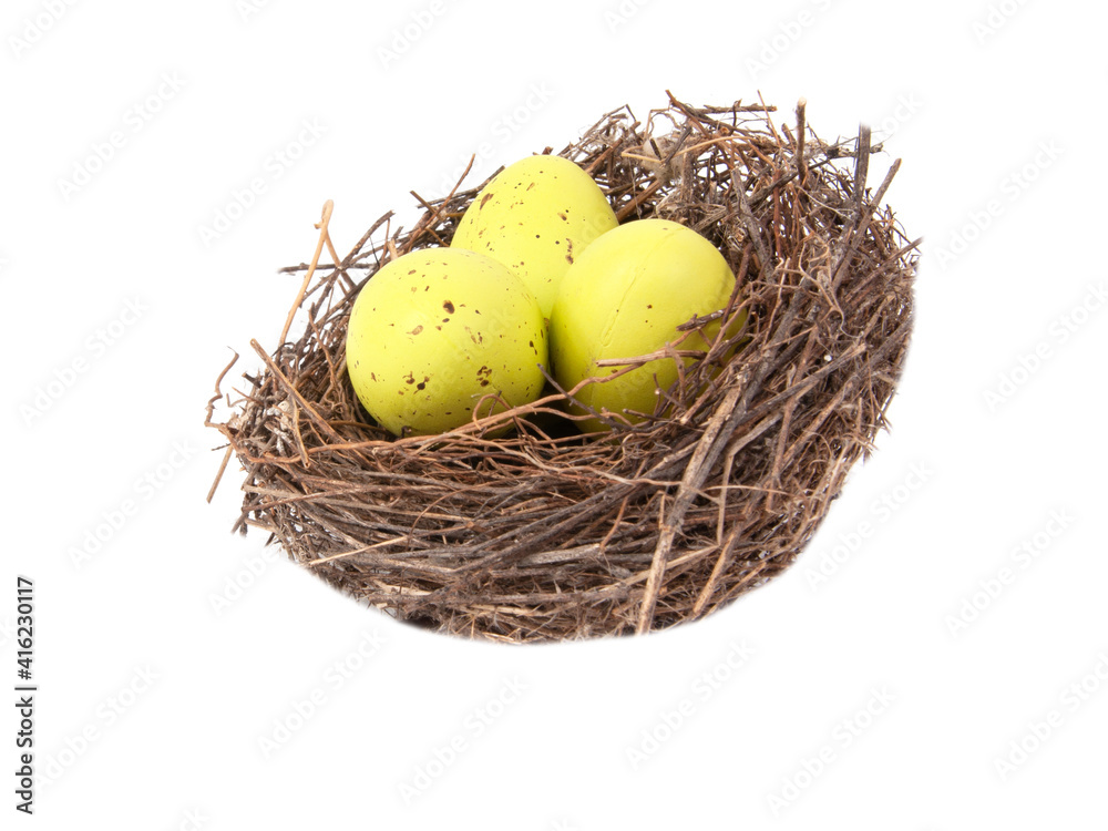Colorful eggs in wooden bird nest isolated on the white background Colorful eggs in wooden bird nest isolated on the white background