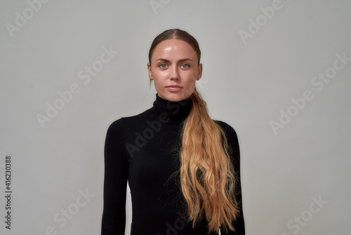 Photography Portrait of beautiful caucasian female model with long hair wearing black turtle