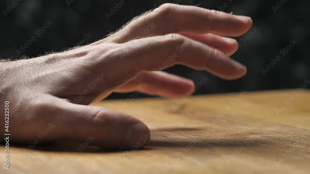 Hand fingers nervously tapping on a wooden table. Rhythmic beating of sound with your fingers, close-up on the hand. Hand fingers nervously tapping on a wooden table. Rhythmic beating of sound with your fingers, close-up on the hand.