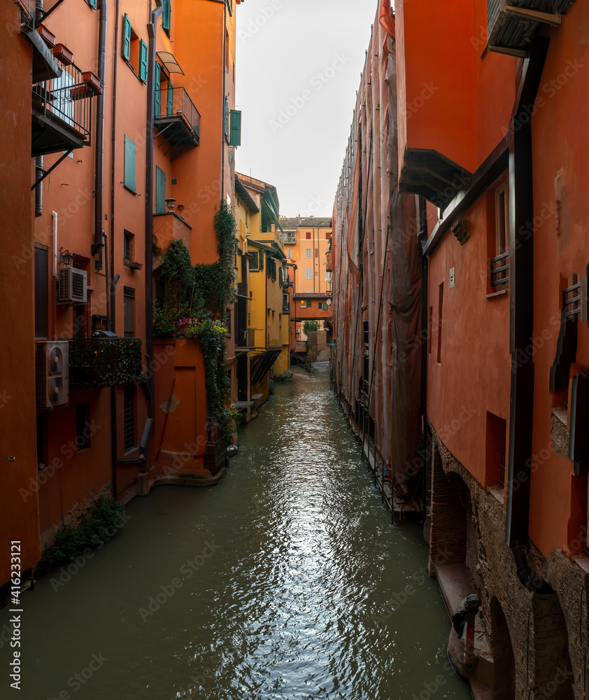 View on the canal on Via Piella, in Bologna, Italy. The old city's canal which still runs under the town. Travel and tourism place. Vertical photo