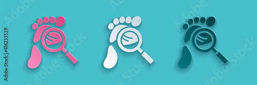 Paper cut Magnifying glass with footsteps icon isolated on blue background. Detective is investigating. To follow in the footsteps. Paper art style. Vector.