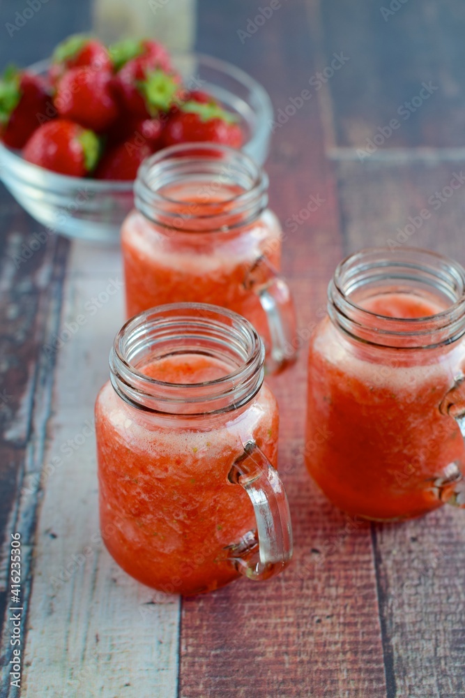 Fresh organic strawberry juice in glass jar Fresh organic strawberry juice in glass jar