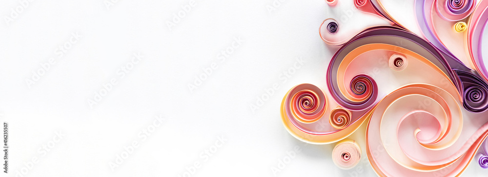 Quilling paper art long banner on white background with copy space. Filigree paper hobby header. Elegant curls and rolls from colored paper for abstract panels.
