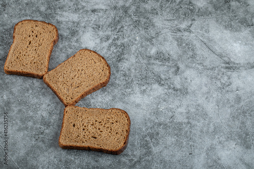 Wallpaper Mural Slices of brown fresh bread on a gray background Torontodigital.ca