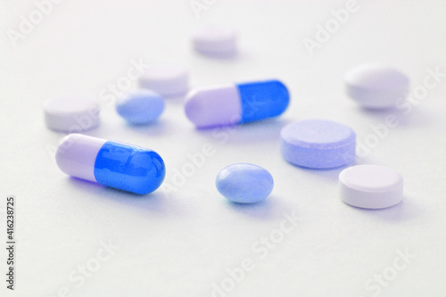 White and blue pills on a white background 