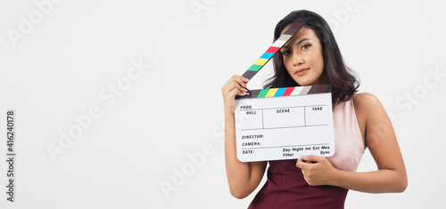 Beautiful asian woman with tan skin and hand s holding clapper board or movie slate use in video production  film  cinema  movies industry on white background.