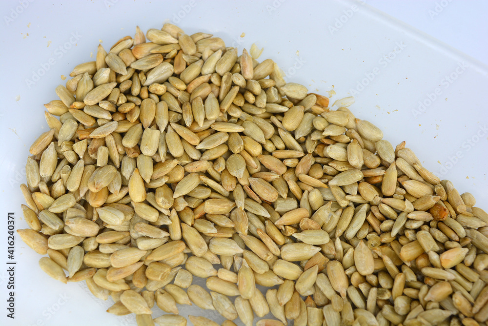 Many tasty fried sunflower grains located in plastic containers and with favorable lighting. Many tasty fried sunflower grains located in plastic containers and with favorable lighting.