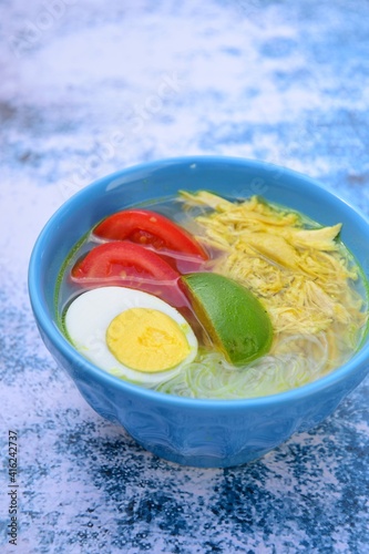 Soto Ayam, traditional Indonesian soup made from broth, chicken, egg, vermicelli and vegetables.