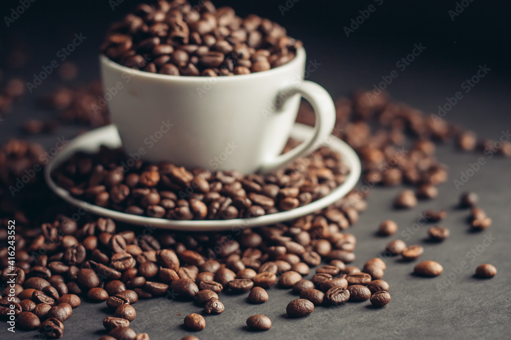 Fototapeta premium white cup with coffee beans on gray background Arabica variety