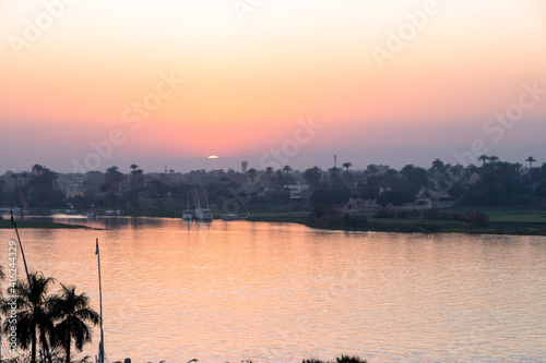 sunset with Nile river from Luxor, Egypt. orange sky reflected over the Nile river. 