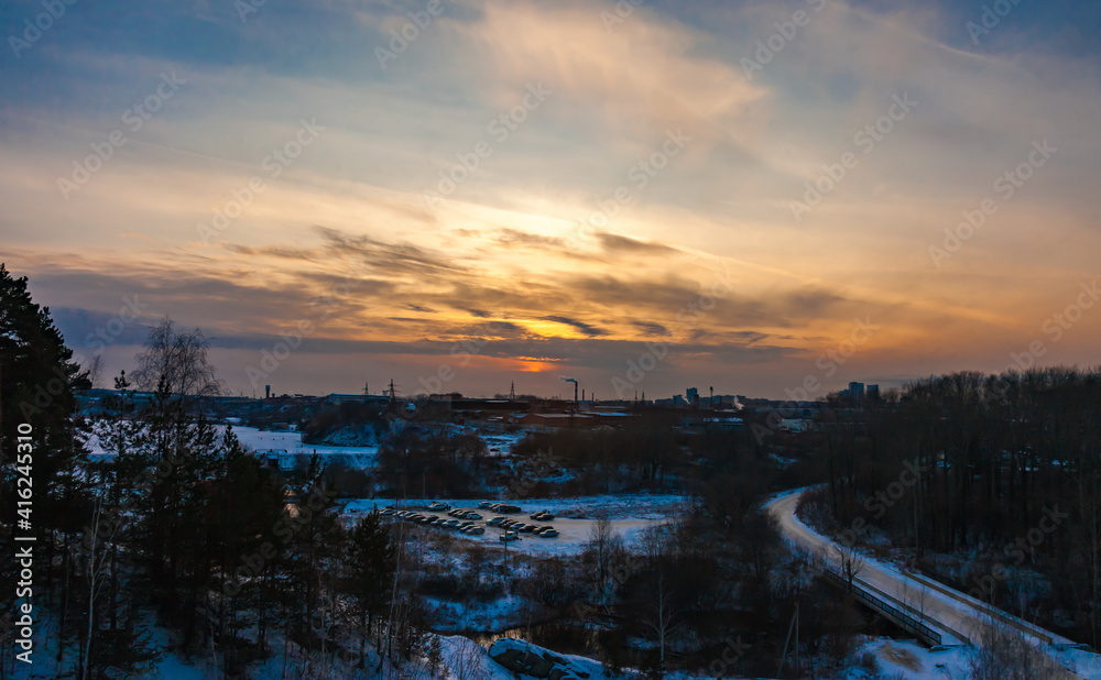 Sunset over the industrial area of the city in winter