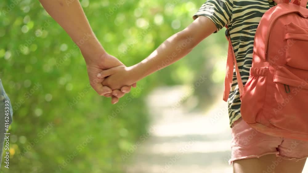 Man walking with girl. Travel lifestyle concept adventure outdoor summer vacations. Happy family hiking in the countryside. Father and daughter walking in the forest. Close up view of hands together. Man walking with girl. Travel lifestyle concept adventure outdoor summer vacations. Happy family hiking in the countryside. Father and daughter walking in the forest. Close up view of hands together.