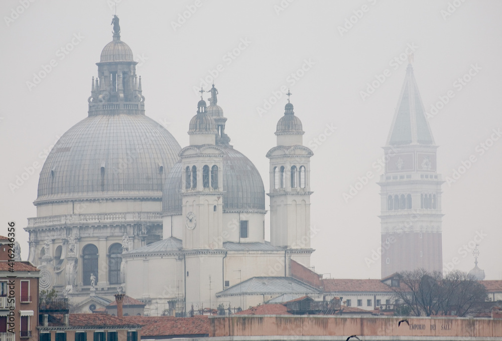 Venice view of the domes of churches and bell towers in the mist of a winter
