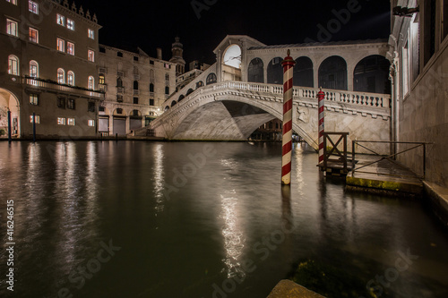 Venice night view of the Rialto bridge over the Grand Canal with the lights reflected on the water