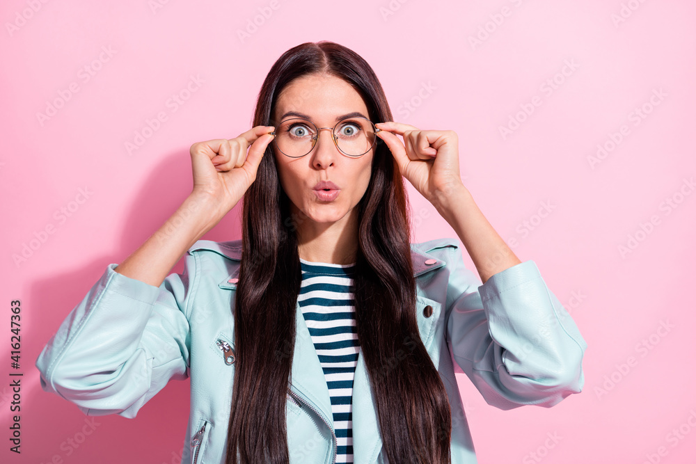 Photo of astonished young woman hold wear glasses amazed sale news reaction isolated on pink color background Photo of astonished young woman hold wear glasses amazed sale news reaction isolated on pink color background