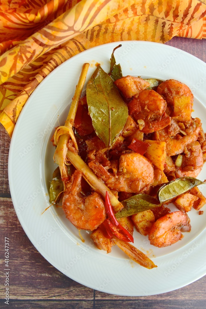 Sambal goreng kentang udang. Fried cubed potato with prawns cooked with coconut milk and spices (Indonesian food) Sambal goreng kentang udang. Fried cubed potato with prawns cooked with coconut milk and spices (Indonesian food)