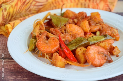 Sambal goreng kentang udang. Fried cubed potato with prawns cooked with coconut milk and spices (Indonesian food) © AmalliaEka