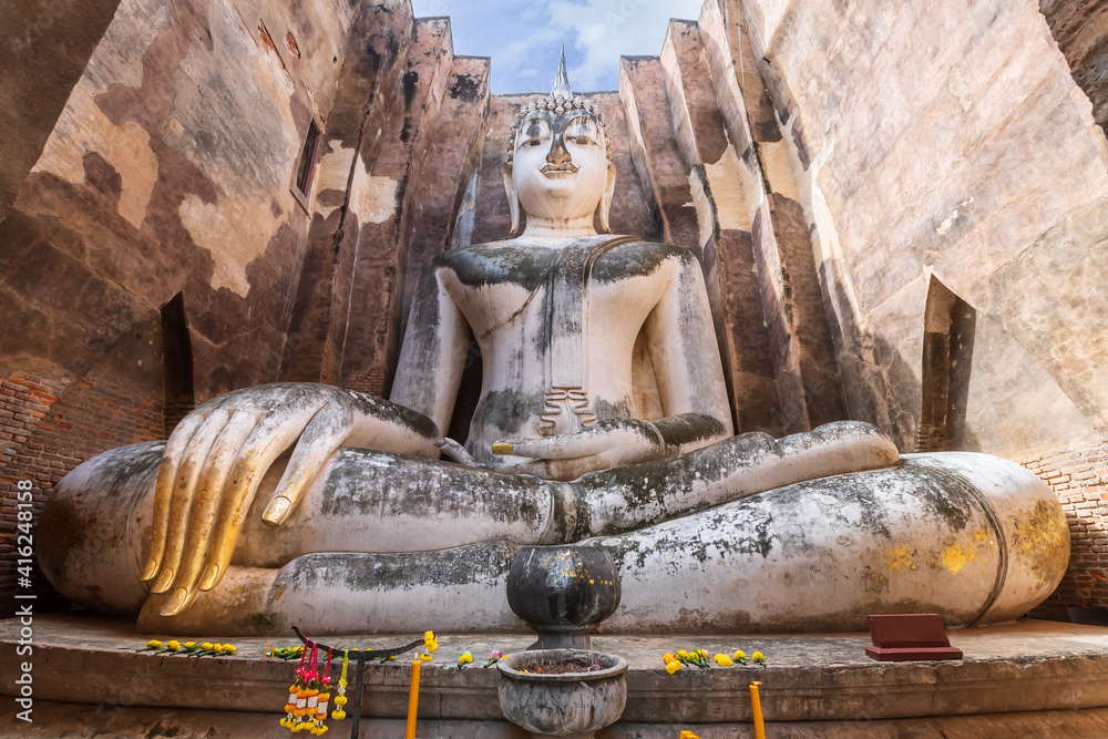 Famous big Buddha statue image named Phra Achana situated in ruined chapel at Wat Si Chum temple, Sukhothai Historical Park, Thailand Famous big Buddha statue image named Phra Achana situated in ruined chapel at Wat Si Chum temple, Sukhothai Historical Park, Thailand