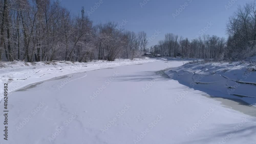 Water reservoir covered with ice and snow. Snow-covered tree on a frosty, sunny and winter day. Blue sky in the drone shot.
Water reservoir covered with ice and snow. Snow-covered tree on a frosty, sunny and winter day. Blue sky in the drone shot.