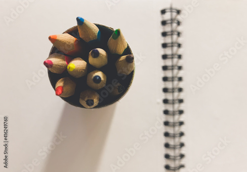 Notebook and pencils, objects on the table photo