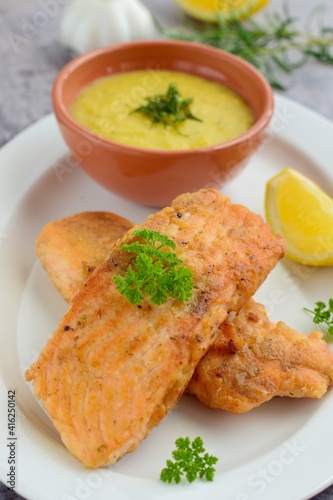 Fried salmon with potato puree with parsley and lemon