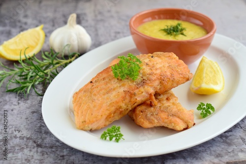 Fried salmon with potato puree with lemon and parsley
