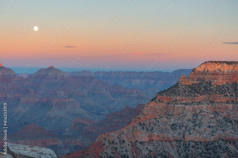 Moon in the grand canyon at sunset.