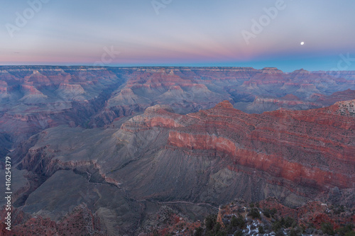Moon in the grand canyon at sunset. © Aliaksei
