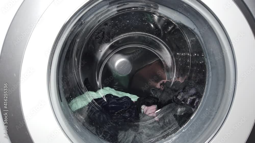 Things are spinning in the drum of the washing machine. Washing at home Things are spinning in the drum of the washing machine. Washing at home