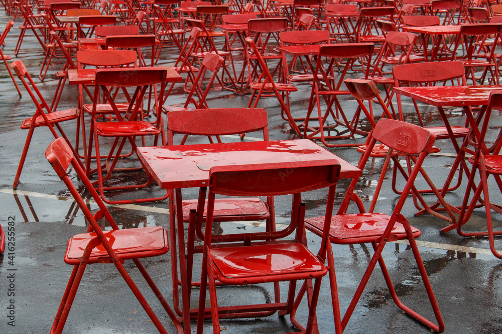 Red table and chairs after heavy rain