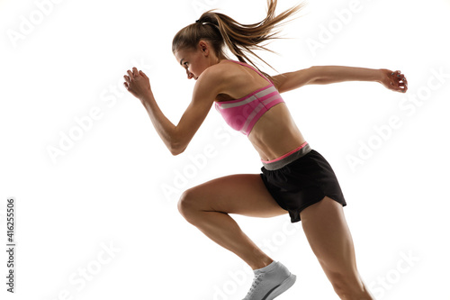 Energy. Caucasian professional female athlete, runner training isolated on white studio background. Muscular, sportive woman. Concept of action, motion, youth, healthy lifestyle. Copyspace for ad.