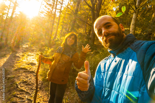 Selfie of a hiker couple in the forest at sunset time. Artikutza forest in Oiartzun, Gipuzkoa. Basque Country