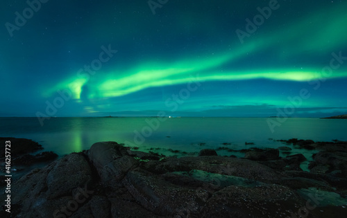 Aurora Borealis on the night sky above the sea