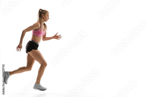 Fototapeta Naklejka Na Ścianę i Meble -  Strong. Caucasian professional female athlete, runner training isolated on white studio background. Muscular, sportive woman. Concept of action, motion, youth, healthy lifestyle. Copyspace for ad.