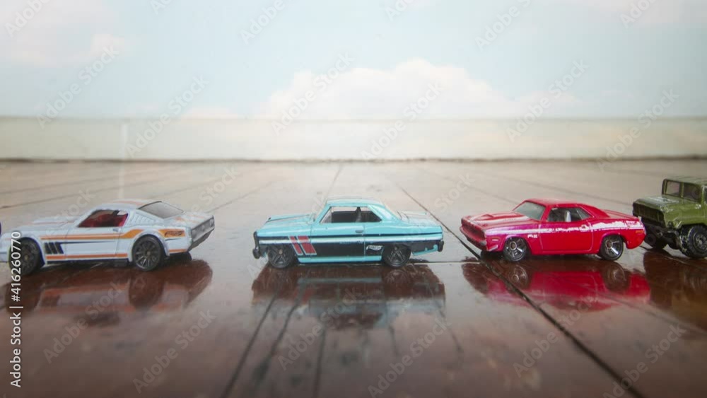 retro old toy cars driving on an old wooden floor stop motion loop