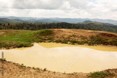 Puddle after rain in clay soil in the mountains
