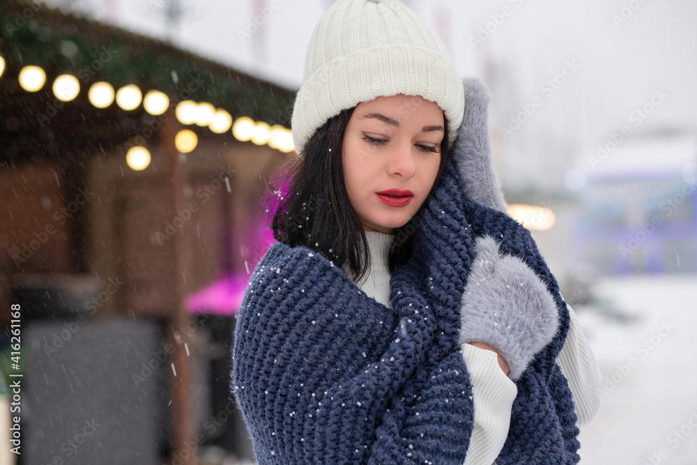 Stylish brunette lady wears knitted cap and scarf