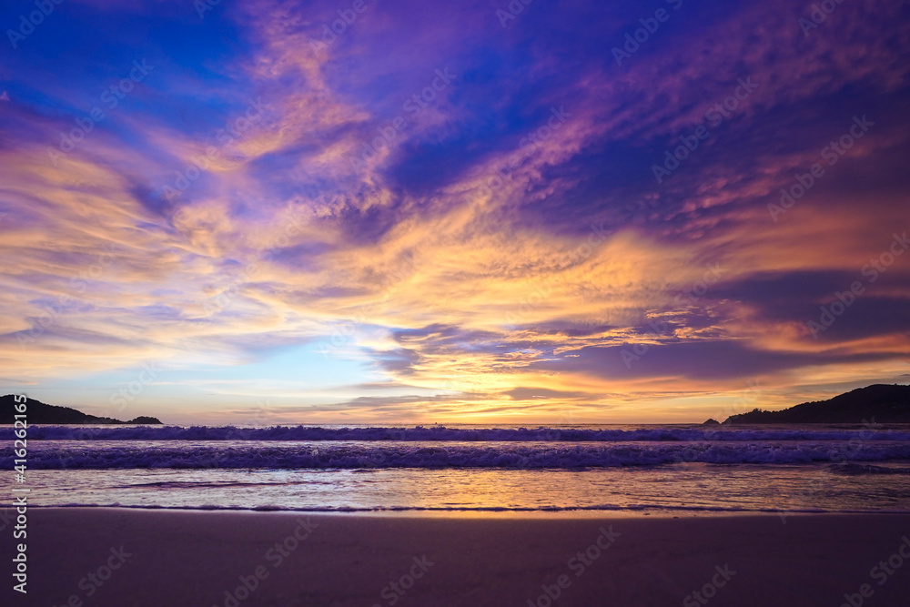 Bright scenic sunset on the beach in a blue orange shade