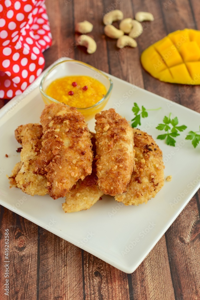 Chicken fingers breaded with cashew and coconut flakes. Served with mango red pepper dip Chicken fingers breaded with cashew and coconut flakes. Served with mango red pepper dip