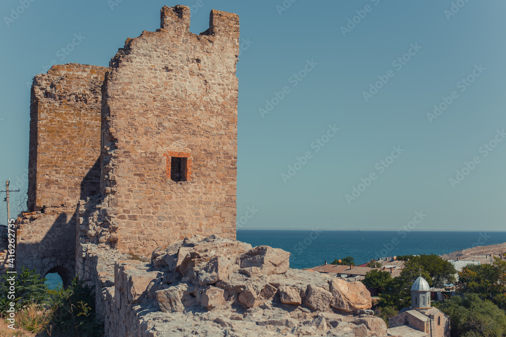 Scenic view of fortification walls of medieval Genoese fortress on Black Sea coast in the southern part of Feodosia city.