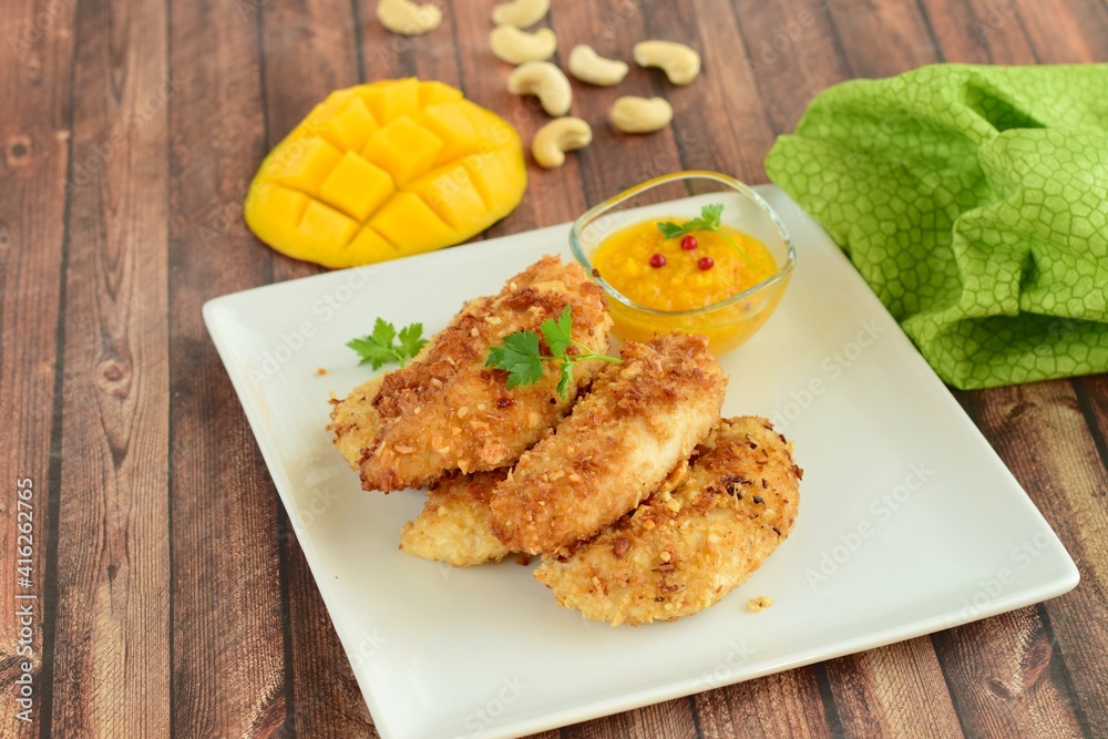 Chicken fingers breaded with cashew and coconut flakes. Served with mango red pepper dip Chicken fingers breaded with cashew and coconut flakes. Served with mango red pepper dip