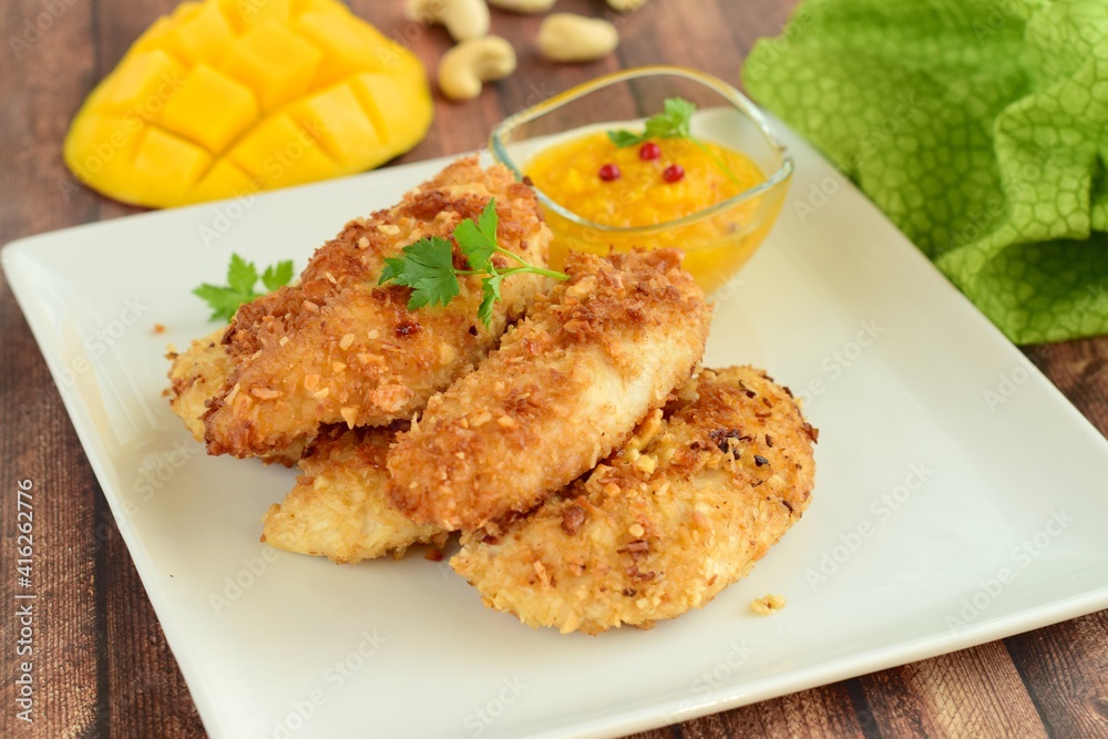 Chicken fingers breaded with cashew and coconut flakes. Served with mango red pepper dip Chicken fingers breaded with cashew and coconut flakes. Served with mango red pepper dip